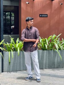 Freelance digital marketer in Calicut standing confidently in a business park.